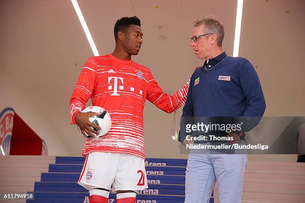 David Alaba of Bayern talks to Peter Stoeger , head coach of Koeln are seen prior to the Bundesliga match between Bayern Muenchen and 1. FC Koeln at...