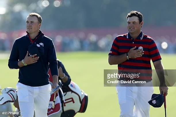 Jordan Spieth and Patrick Reed of the United States walk to the ninth green with their hands on their hearts as the crowd sings the national anthem...