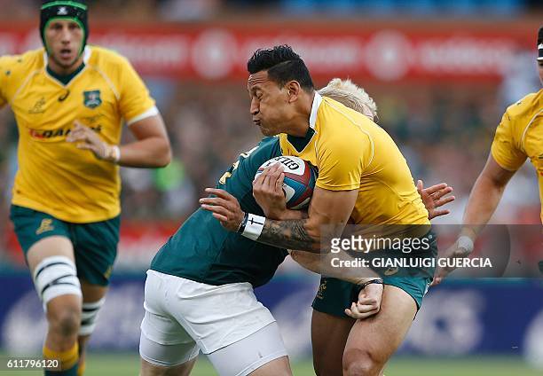 South African prop Vincent Koch tackles Australian fullback Israel Folau during the Castle Lager Rugby Championship international test match between...