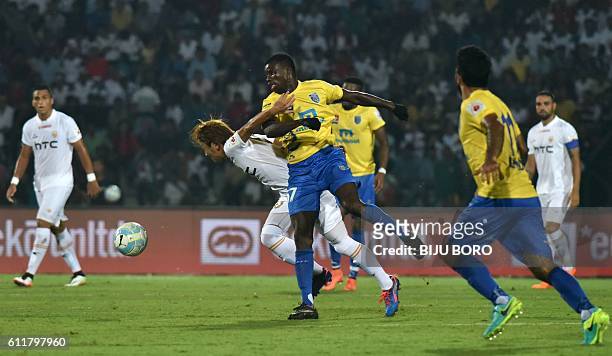Kerala Blasters FC's midfielder Didier Boris Kadio and Northeast United FC's midfielder Katsumi Yusa fight for the ball during the Indian Super...