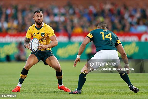 South African wing Brian Habana tries to prevent Australian flyhalf Quade Cooper from breaking through defence during the Castle Lager Rugby...