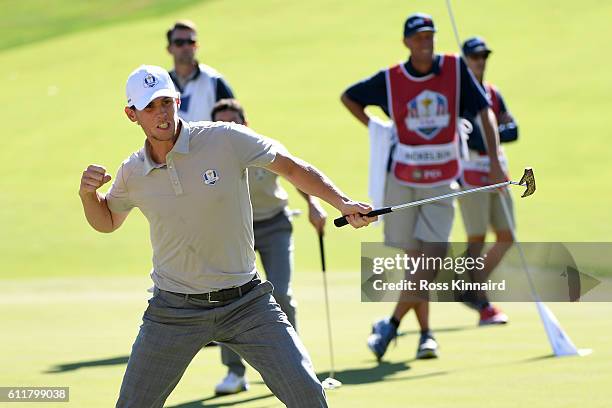 Thomas Pieters of Europe reacts after a putt on the 16th green to win the match as Rory McIlroy looks on during morning foursome matches of the 2016...