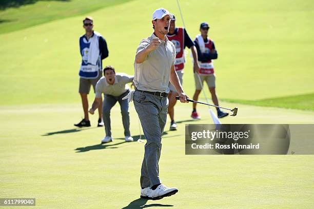 Thomas Pieters of Europe reacts after a putt on the 16th green to win the match as Rory McIlroy looks on during morning foursome matches of the 2016...