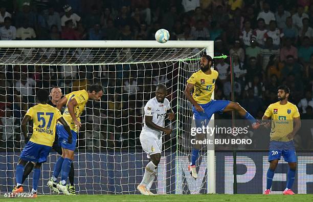 Kerala Blasters FC's defender Sandesh Jhingan heads the ball clear during the Indian Super League football match between Northeast United FC and...