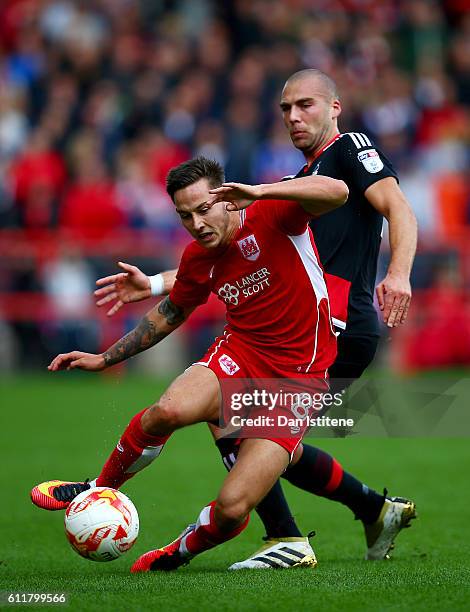 Joel Ekstrand of Bristol City battles for the ball with Pajtim Kasami of Nottingham Forest during the Sky Bet Championship match between Bristol City...