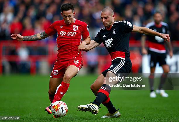 Joel Ekstrand of Bristol City battles for the ball with Pajtim Kasami of Nottingham Forest during the Sky Bet Championship match between Bristol City...