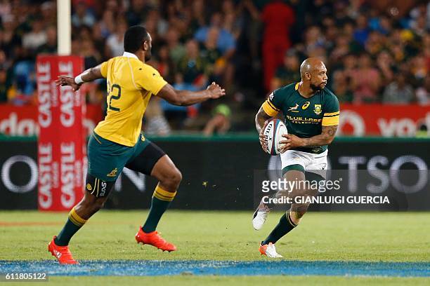 South Africa's centre Lionel Mapoe runs with the ball during the Castle Lager Rugby Championship International test match between South Africa and...