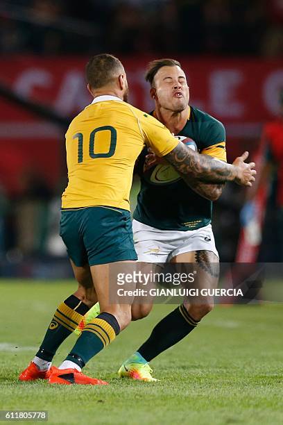 South Africa's wing Francois Hougaard vies with Australia's flyhalf Quade Cooper during the Castle Lager Rugby Championship International test match...