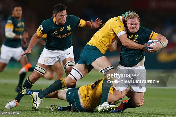 South African hooker and Captain Adriaan Strauss vies with Australia's players during the Castle Lager Rugby Championship International test match...