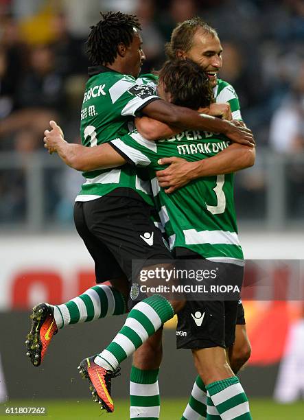 Sporting's Serbian forward Lazar Markovic celebrates with teammates forward Gelson Martins and Dutch forward Bas Dost after scoring a goal during the...