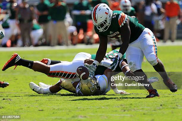 Shaquille Quarterman of the Miami Hurricanes recovers a fumble for a touchdown during the first half against the Georgia Tech Yellow Jackets at Bobby...