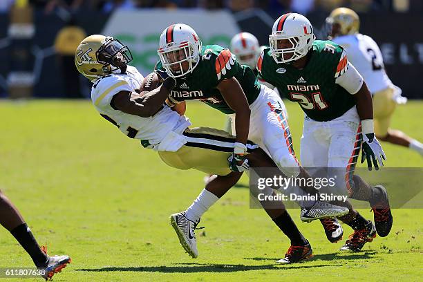 Clinton Lynch of the Georgia Tech Yellow Jackets is tackled by Josh Selembo of the Georgia Tech Yellow Jackets during the first half at Bobby Dodd...