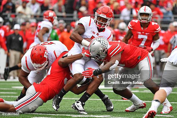 Robert Martin of the Rutgers Scarlet Knights is tackled before the line of scrimmage by Chris Worley of the Ohio State Buckeyes and Raekwon McMillan...