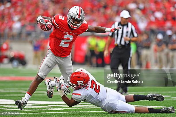 Dontre Wilson of the Ohio State Buckeyes is dropped in the backfield by Kiy Hester of the Rutgers Scarlet Knights in the first quarter at Ohio...