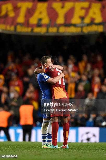 Chelsea's John Terry and Galatasaray's Didier Drogba embrace after the final whistle