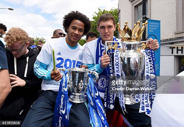 Chelsea's Isaiah Brown and Andreas Christensen hold the Premier League and Capital One Cup trophy on the open top bus during the parade.