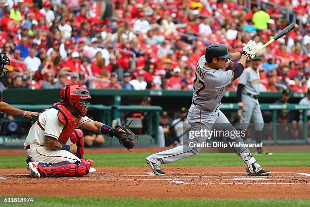 Jung Ho Kang of the Pittsburgh Pirates hits a three-run home against the St. Louis Cardinals in the first inning at Busch Stadium on October 1, 2016...