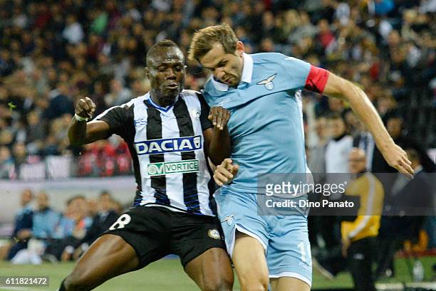 Emmanuel Agyemang Badu of Udinese Calcio competes with Senad Lulic of SS Lazio during the Serie A match between Udinese Calcio and SS Lazio at Stadio...