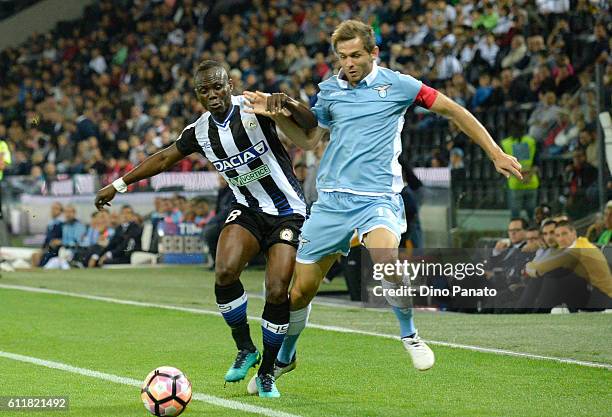 Emmanuel Agyemang Badu of Udinese Calcio competes with Senad Lulic of SS Lazio during the Serie A match between Udinese Calcio and SS Lazio at Stadio...