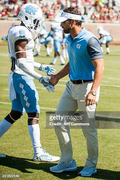 Head coach of the North Carolina Tar Heels Larry Fedora talks to K.J. Sails of the North Carolina Tar Heels before the game against the Florida State...