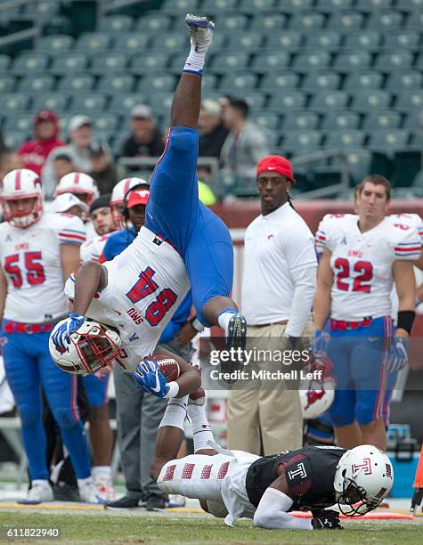 Artrel Foster of the Temple Owls upends Jeremiah Gaines of the Southern Methodist Mustangs in the third quarter at Lincoln Financial Field on October...