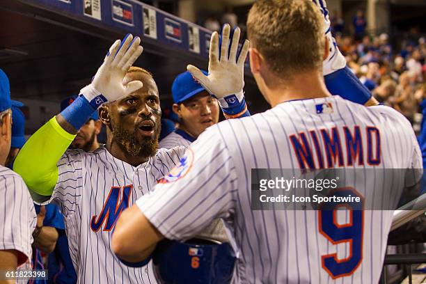 New York Mets Infield Jose Reyes [3276] high fives Brandon Nimmo [9128] after hitting a game tying 2 run nom run, in the ninth inning of a regular...