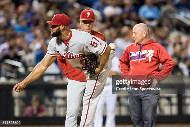 Philadelphia Phillies Pitcher Luis Garcia [9007] throws as manager Peter Mackanin and trainer Scott Sheridan look on, after Garcia was hit by a...