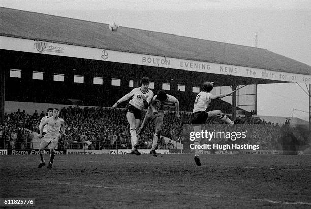 Chelsea's Colin Lee challenges for a high cross in the Bolton penalty area.