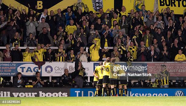 Burton Albion players celebrate after Jamie Ward scores the opener during the Sky Bet Championship match between Burton Albion and Queens Park...