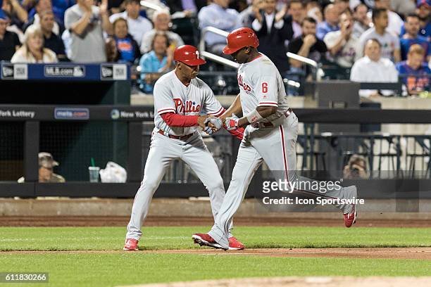 Philadelphia Phillies First base Ryan Howard [3800] is congratulated by third base coach Juan Samuel, after hitting a solo home run, in the fifth...