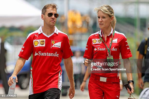 Sebastian Vettel of Scuderia Ferrari with Britta Roeske, Ferrari Press Officer. At the paddock of the Formula 1 Petronas Malaysia Grand Prix held at...