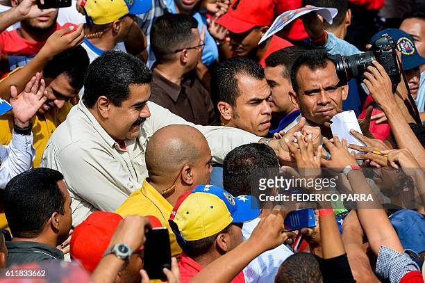 Venezuelan President Nicolas Maduro greet supporters during the commemoration of the 2nd anniversary of the death of deputy Robert Serra at...