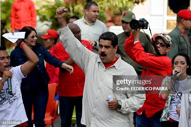 Venezuelan President Nicolas Maduro raises his fist during the commemoration of the 2nd anniversary of the death of deputy Robert Serra at Miraflores...