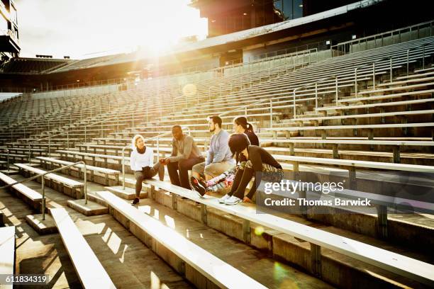 friends resting during workout in stadium - liberty stadion stock pictures, royalty-free photos & images