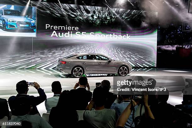 Visitors look at the new Audi S5 car during the press preview of the Paris Motor Show at Paris Expo Porte de Versailles on September 29, 2016 in...