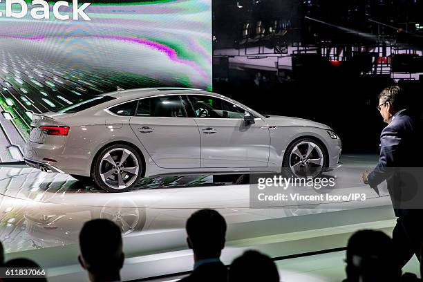 Visitors look at the new Audi S5 car during the press preview of the Paris Motor Show at Paris Expo Porte de Versailles on September 29, 2016 in...