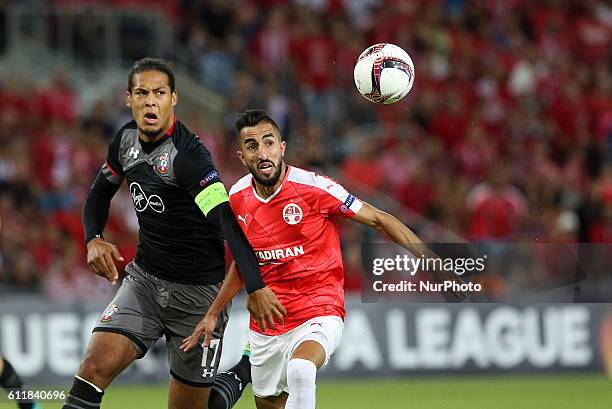 Hapoel Beer-Sheva's Israeli defender Ben Bitton vies for the ball against Southampton's Van Dijk during their UEFA Europa League football match group...