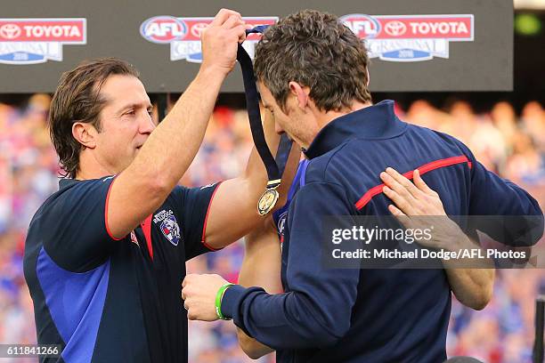 Bulldogs head coach Luke Beverage gives his medal to the injured Robert Murphy during the 2016 AFL Grand Final match between the Sydney Swans and the...