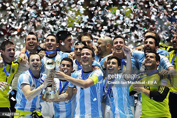 Fernando Wilhelm of Argentina lifts the winners trophy during the FIFA Futsal World Cup Final match between Russia and Argentina at the Coliseo el...