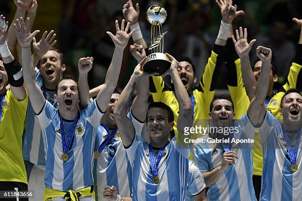 Fernando Wilhelm of Argentina lifts the winners trophy during the FIFA Futsal World Cup Final match between Russia and Argentina at the Coliseo el...
