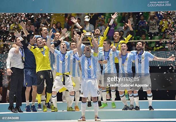 Alamiro Vaporaki of Argentina lifts the winners trophy during the FIFA Futsal World Cup Final match between Russia and Argentina at the Coliseo el...