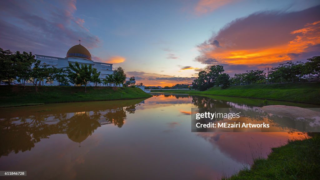 Majestic Sunset Over a Mosque by the lake with perfect reflection