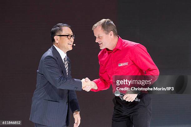 President and CEO of Toyota Motor Corporation Akio Toyoda and the Finnish rally driver Tommi Makinen deliver a speech during the press preview of the...