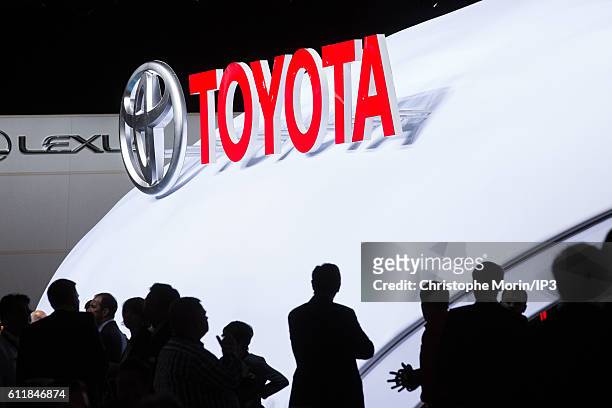 Visitors look at the stand of Toyota brand during the press preview of the Paris Motor Show at Paris Expo Porte de Versailles on September 29, 2016...