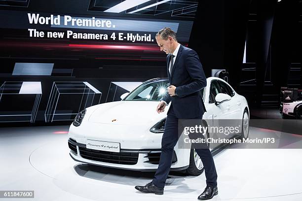 Of Porsche Oliver Blume presents their latest Porsche Panama 4 E Hybrid car during the press preview of the Paris Motor Show at Paris Expo Porte de...