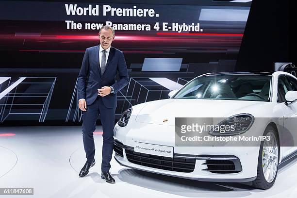 Of Porsche Oliver Blume presents their latest Porsche Panama 4 E Hybrid car during the press preview of the Paris Motor Show at Paris Expo Porte de...