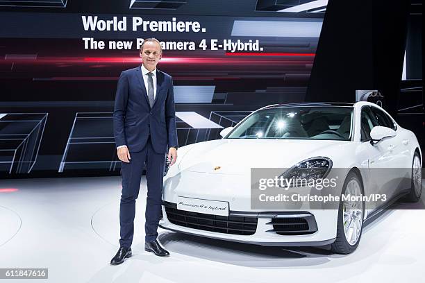 Of Porsche Oliver Blume presents their latest Porsche Panama 4 E Hybrid car during the press preview of the Paris Motor Show at Paris Expo Porte de...