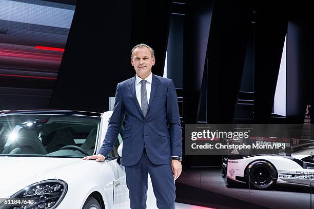 Of Porsche Oliver Blume presents their latest Porsche Panama 4 E Hybrid car during the press preview of the Paris Motor Show at Paris Expo Porte de...