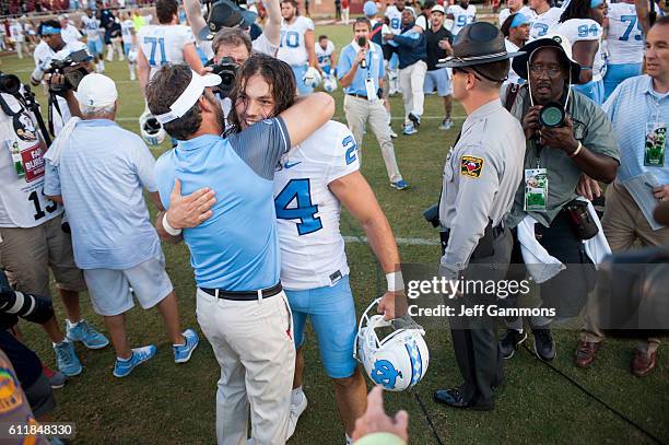 Nick Weiler of the North Carolina Tar Heels celebrates with the Tar Heels head coach Larry Fedora after their win over the Florida State Seminoles at...
