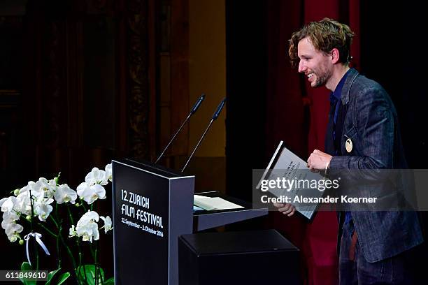 Jan Gassmann gives his acceptance speech after receiving the 'Focus' award on stage during the Award Night Ceremony during the 12th Zurich Film...